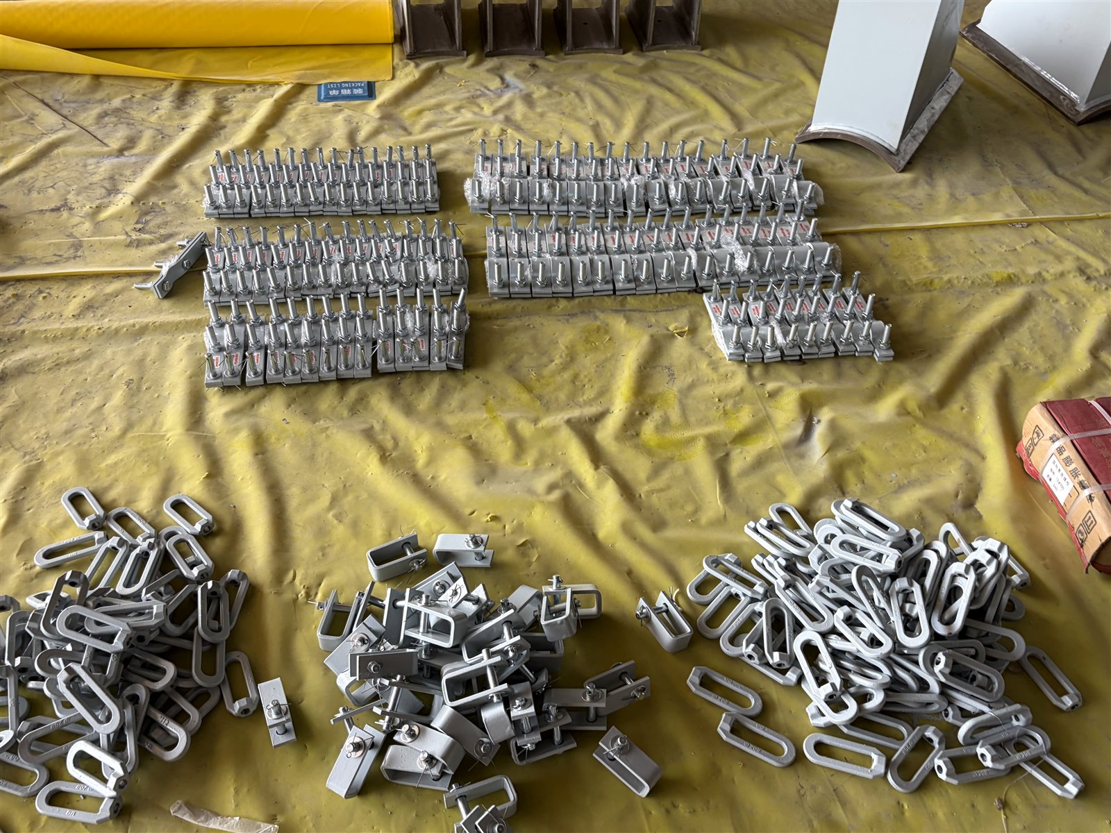 Forged eye nuts and beam clamps staged for packing