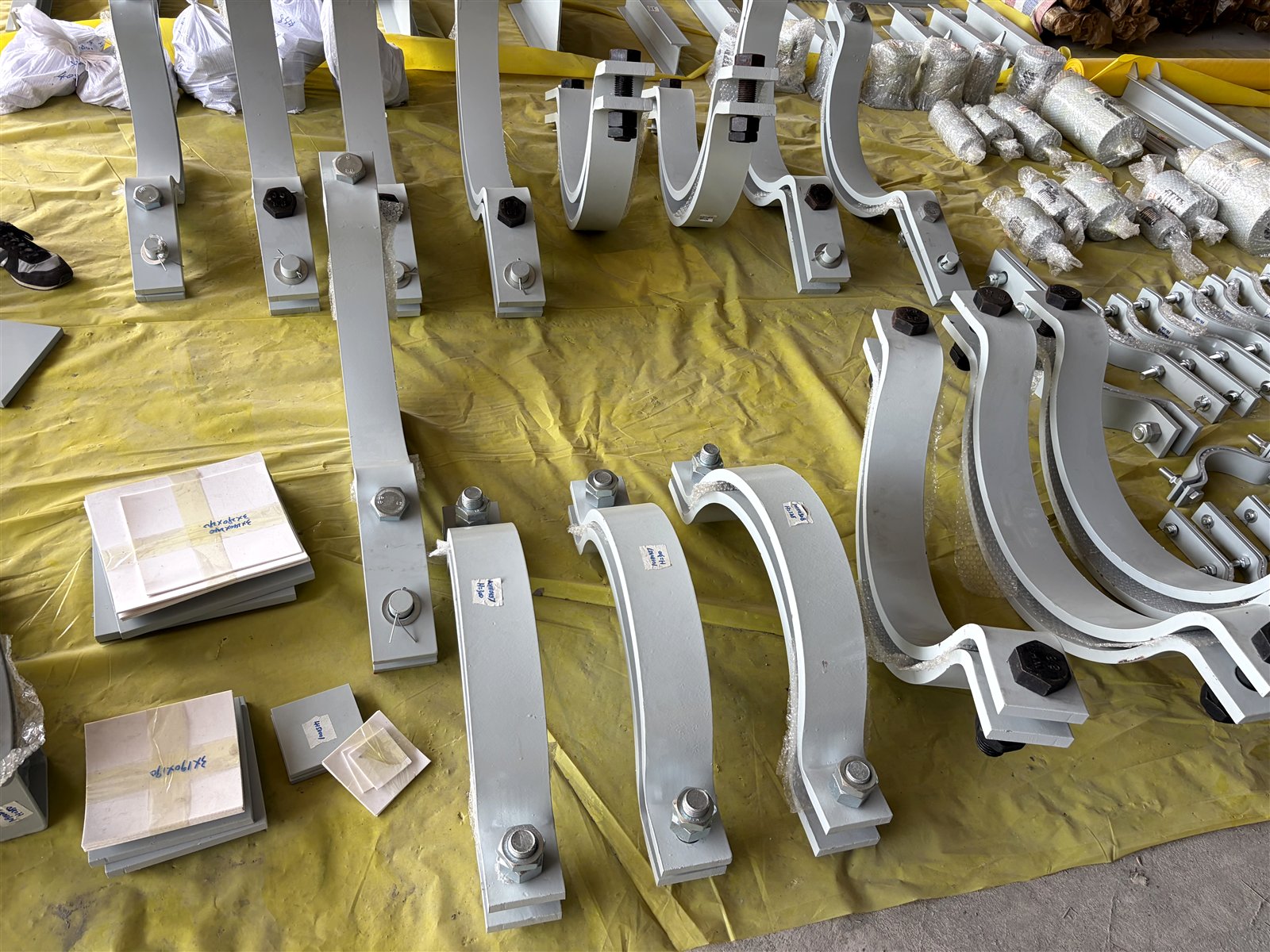 Insulated pipe supports with slide plates, showing components inside and outside the insulation envelope